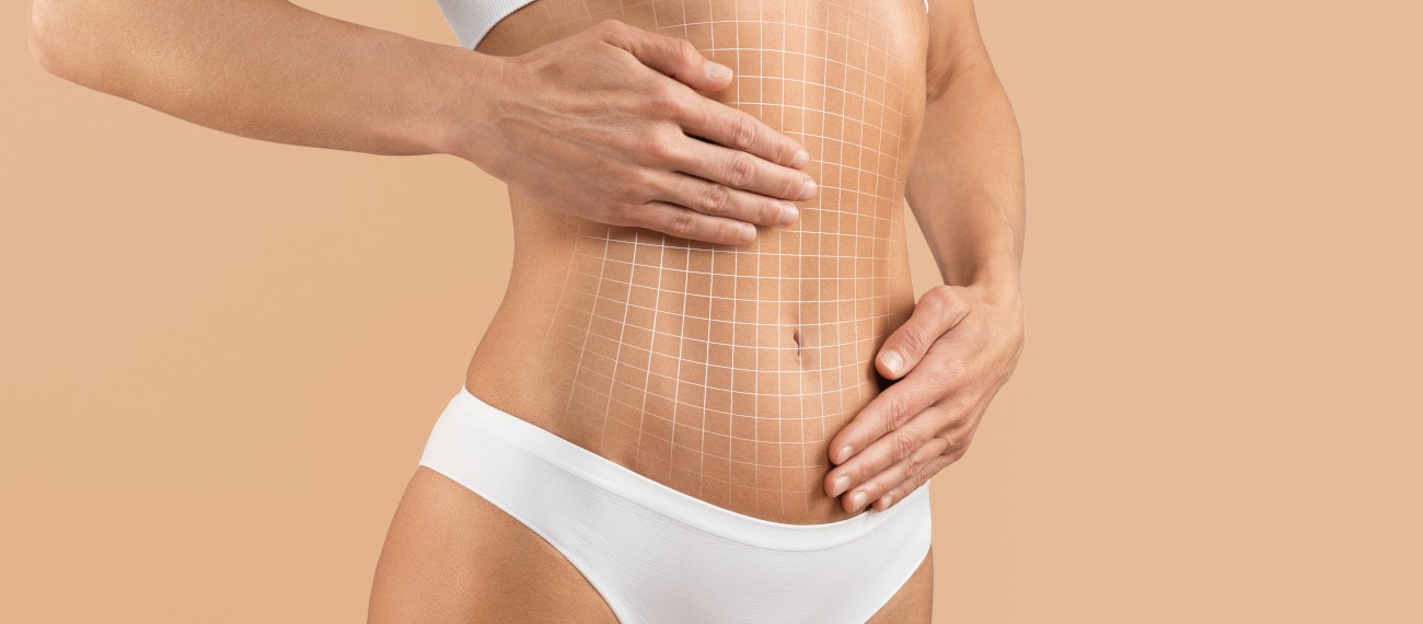 Frau zeigt gestrafften Bauch